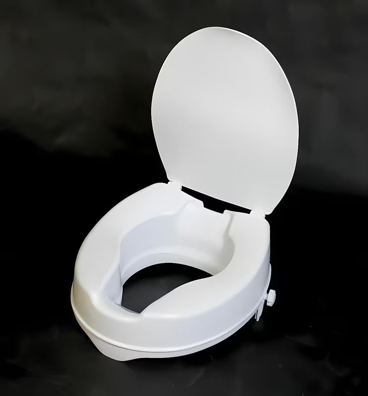 Bílé zvýšené WC sedátko Ridder z polypropylenu pro pohodlnější sedání a vstávání