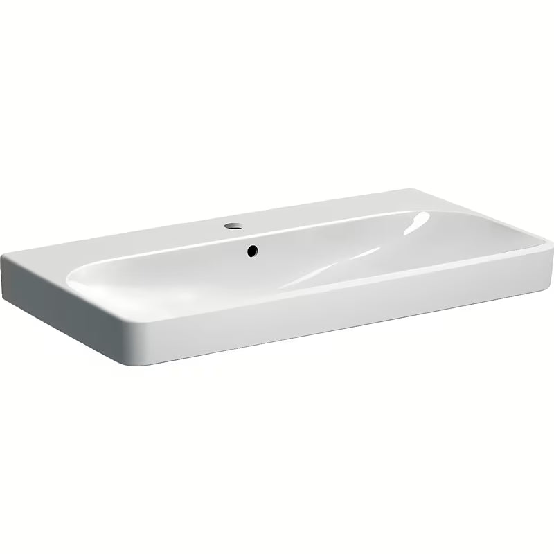 Bílé závěsné umyvadlo Geberit Smyle Square 90x48 cm ze sanitární keramiky s přepadem a otvorem pro baterii.
