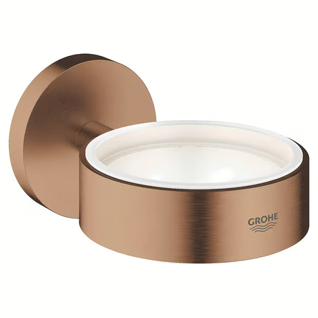 Kovový držák bez skleničky Grohe Essentials v povrchové úpravě Brushed Warm Sunset se skrytým upevněním.