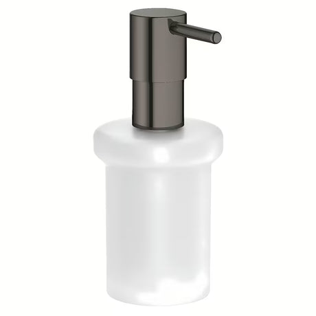 Dávkovač mýdla Grohe Essentials bez držáku v provedení hard graphite, skleněná nádobka a kovové prvky.