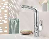 Wysoka jednouchwytowa bateria umywalkowa Grohe Eurostyle New w chromie z obrotową wylewką i zestawem odpływowym.