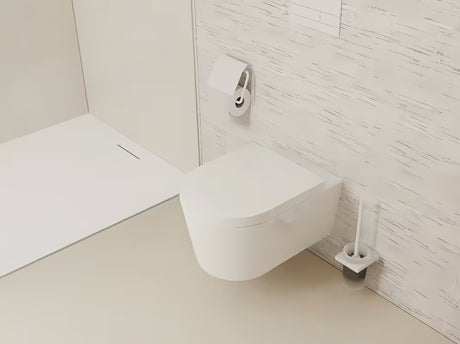 Nástěnná WC štětka hansgrohe AddStoris v matné bílé s držákem z kovu a skleněnou nádobou.