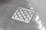 Podlahová vpusť Ravak SN501 s plastovým tělem a nerezovou mřížkou, průměr 10,5 cm.